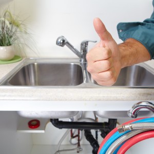 plumber fixing sink faucet
