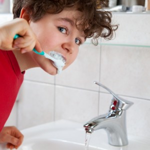 Cute kid brushing teeth